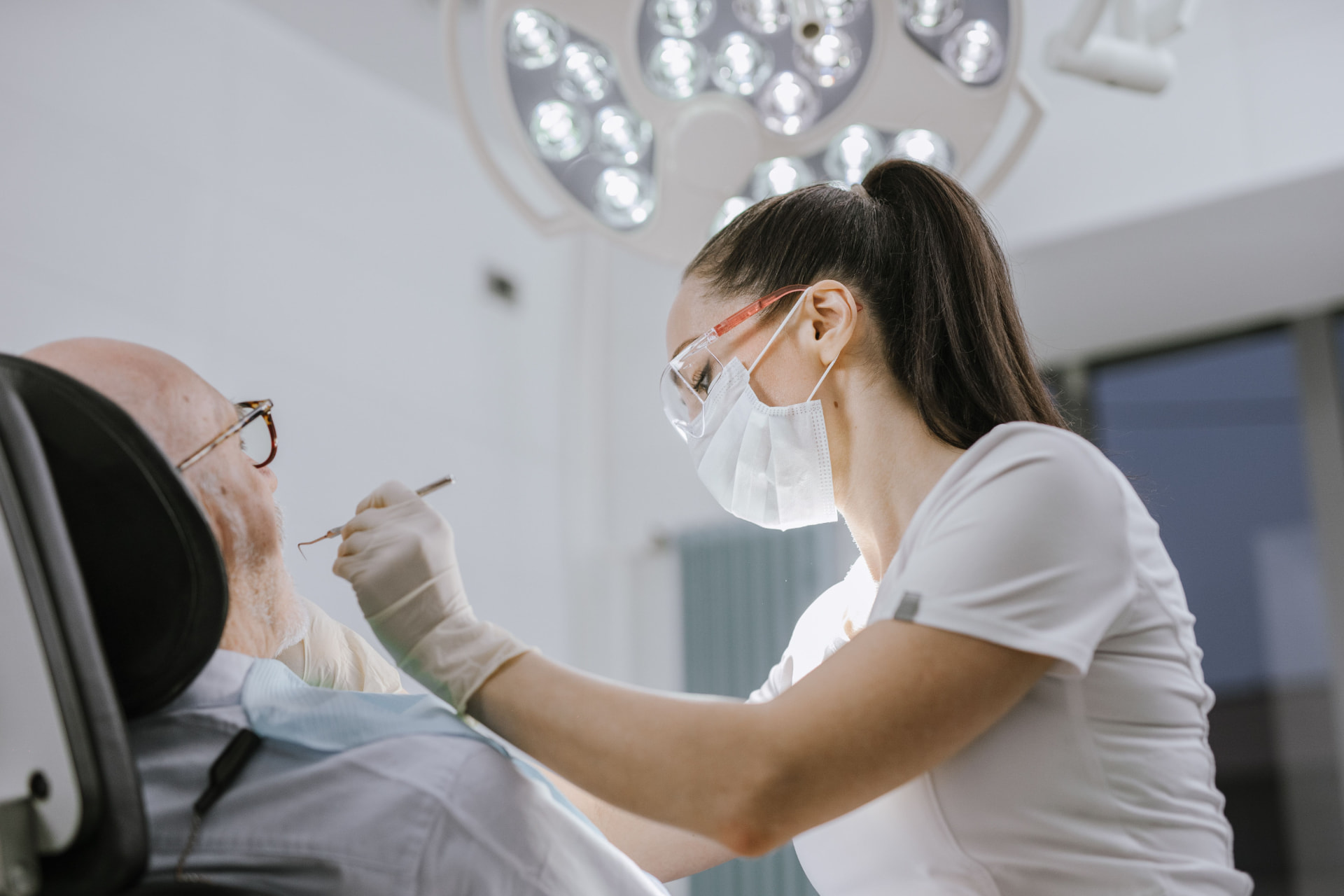 Dentist carefully examining a patient
